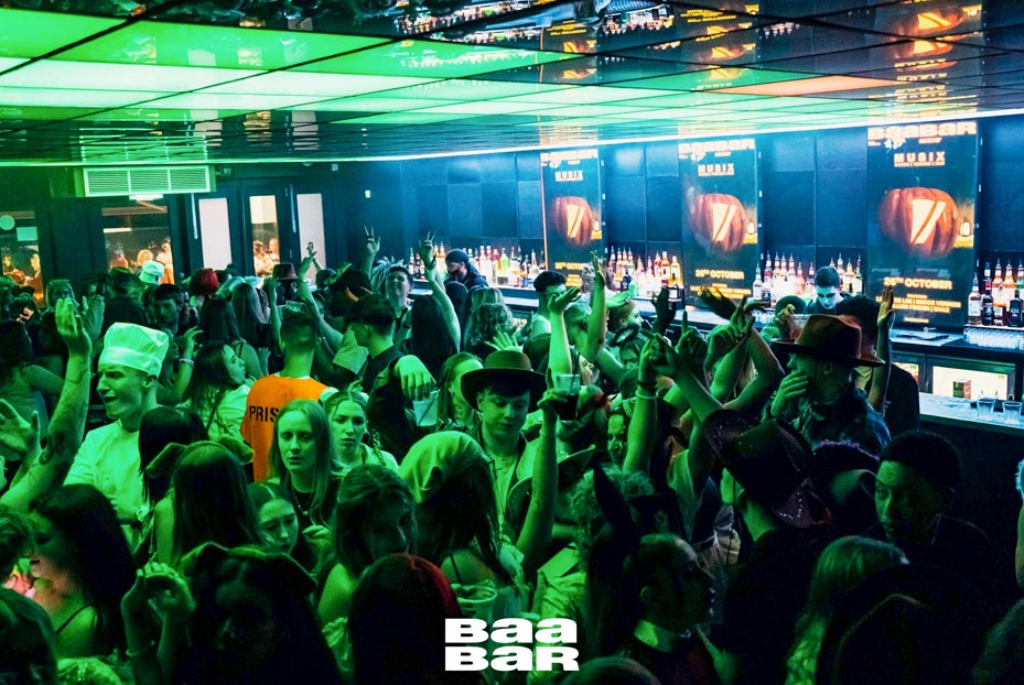 Clubbers dancing and drinking downstairs in Baa bar