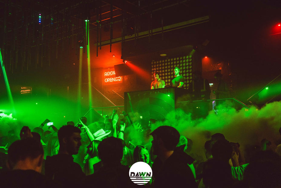 DJs on the decks with clubbers on the dance floor