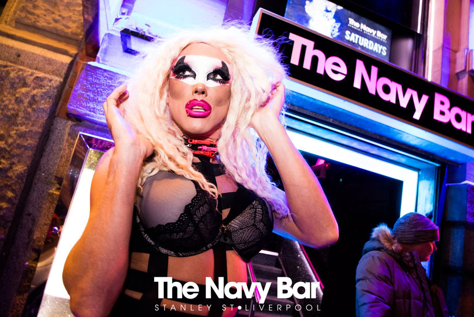 Outside Navy bar in Liverpool at night showing drag queen