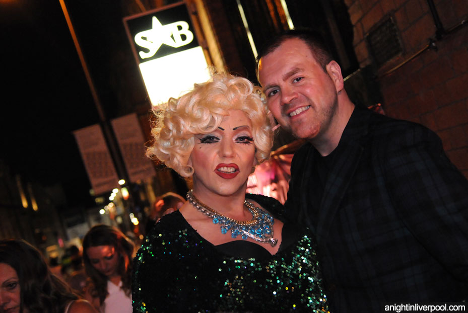 Drag queen and friend outside Superstar Boudoir at night